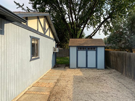 Shed and RV parking behind fence before new paint