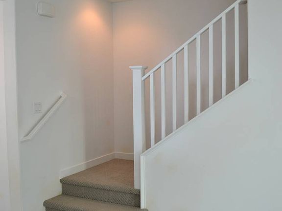 ElevationHomesite 18 has wood-look floors on the lower level and painted stair rails.