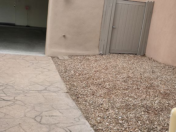 Backyard access in the front with a locked gate