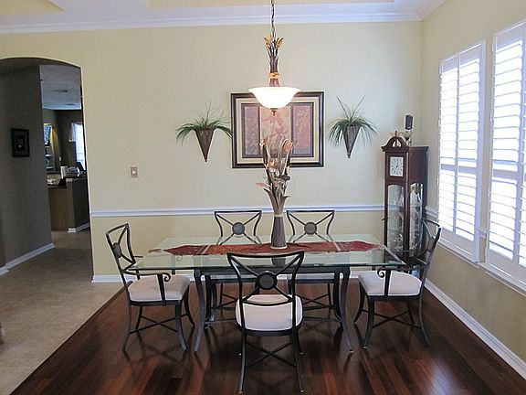 FORMAL DINING ROOM W/ BRAZILIAN HARDWOODS ANDDESIGNER CHANDALIER.