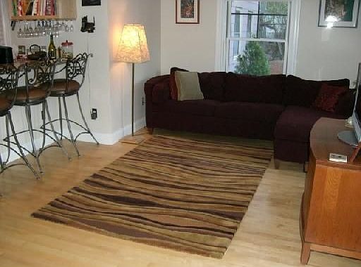 Hardwood floors & crown moulding accent the living room