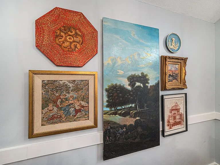 Admire a curated collection of paintings with a subtle vintage charm, adding character and warmth to this inviting living space.