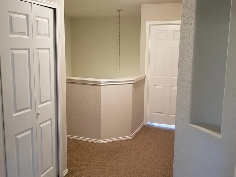 Upstairs hallway looking towards front entry and master bedroom door