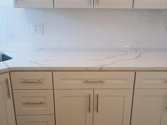 kitchen area with ample cabinets with granite countertops