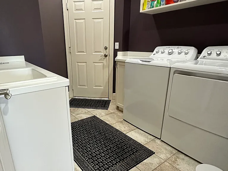 Spacious laundry with full sized washer and dryer