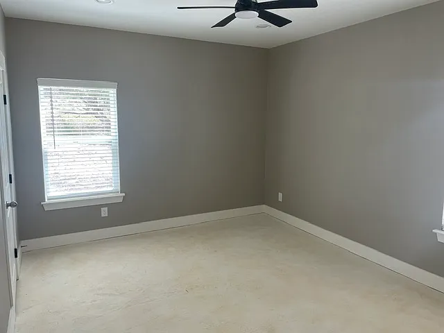 Primary bedroom downstairs with ceiling fan, Cat 6 and coaxial for TV.