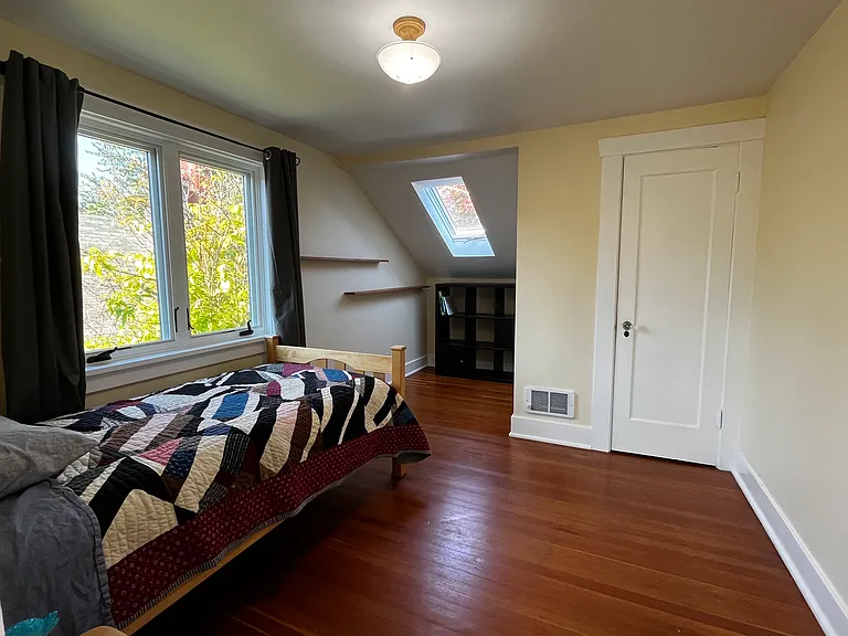 One of the two bedrooms on the second floor. Skylight and spacious closet. Twin bed that can convert to twin bunk beds. Fir floors and original light fixture.