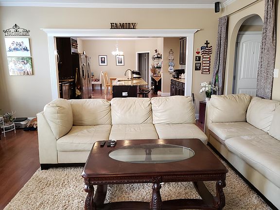 Living room view into the open kitchen and kitchen dining area. The door on the end leads to a bedroom with the bathroom next to it.