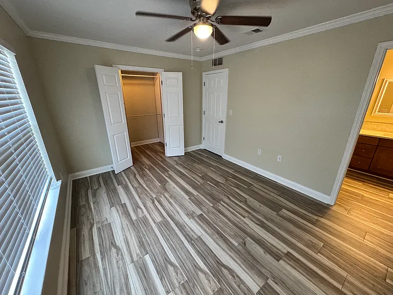 Master bedroom with the closet on the left and a private bathroom on the right.