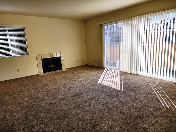 Large living room with fireplace and outside balcony