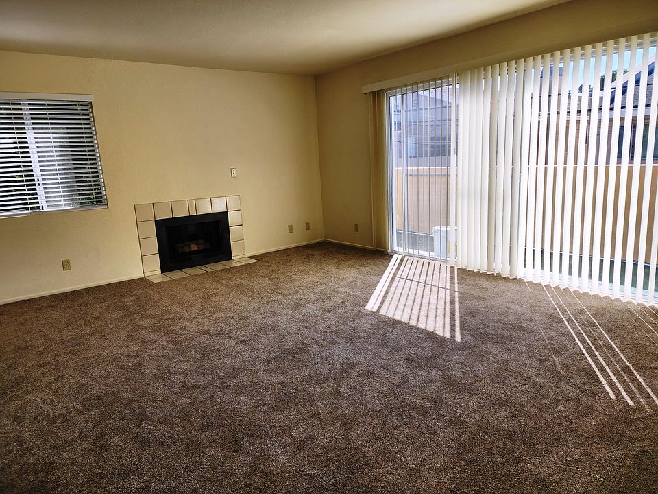 Large living room with fireplace and outside balcony