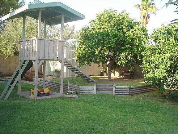 The play area along with the pool make for a fun backyard with plenty of grass