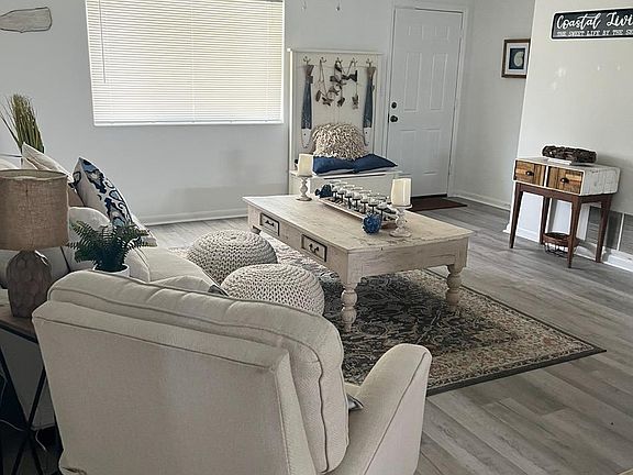 Spacious living room showing the door of the main entrance.