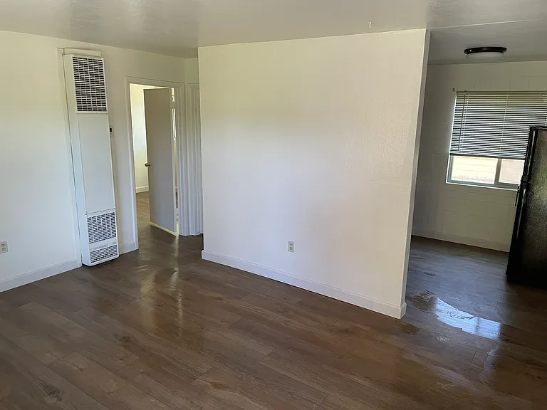 Living room view looking towards kitchen and bedroom