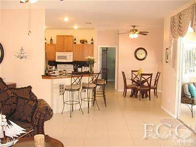 Notice the tile, breakfast bar, and eat-in kitchen.