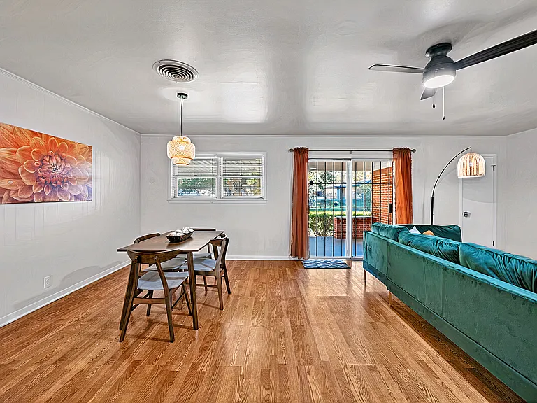 Dining area with seating for four and open layout, suitable for meals or workspace.