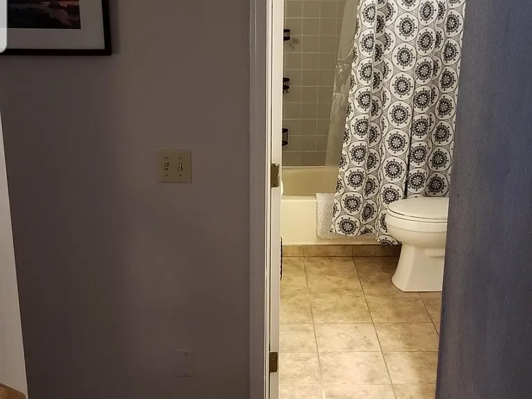 view from the stairs leading down to the garage and other two bedrooms.