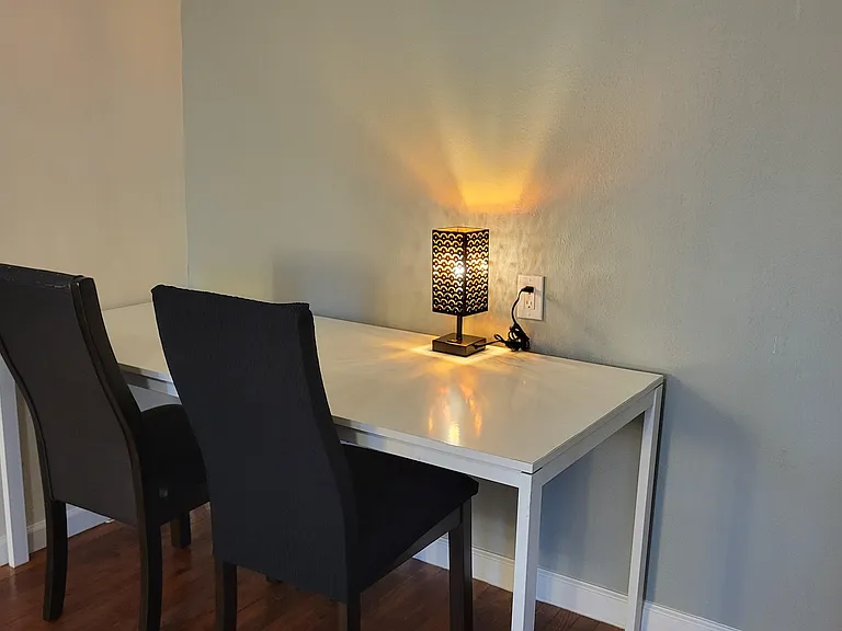 Quiet study nook with seating for two ideal for focused work or reading.