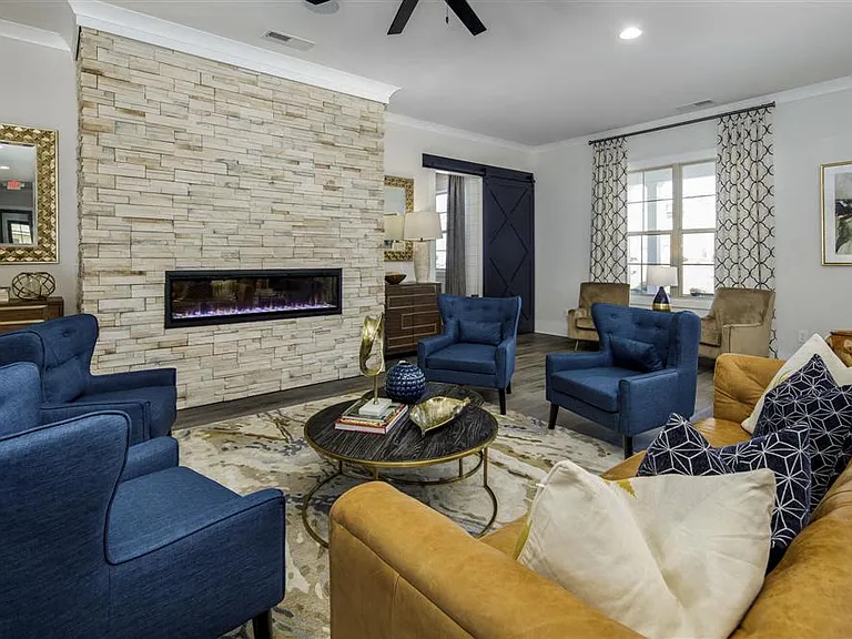 Clubhouse living room with ample seating, and fireplace