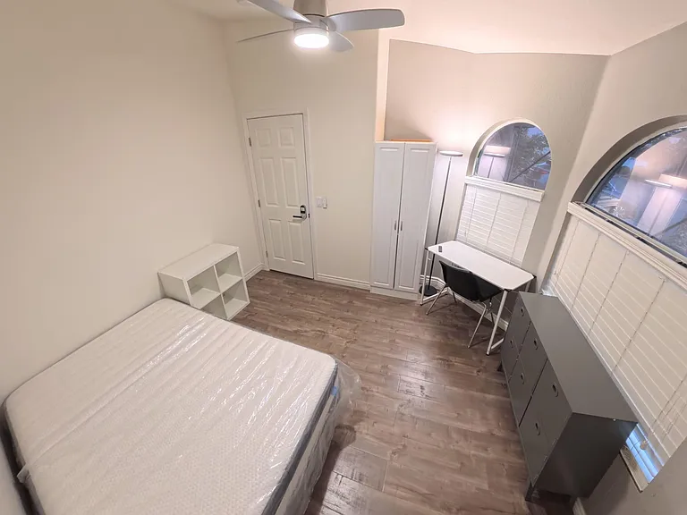 Comfy room with new memory foam bed, desk, LED lighting, ample storage & scenic views through 3 tinted street-facing windows.