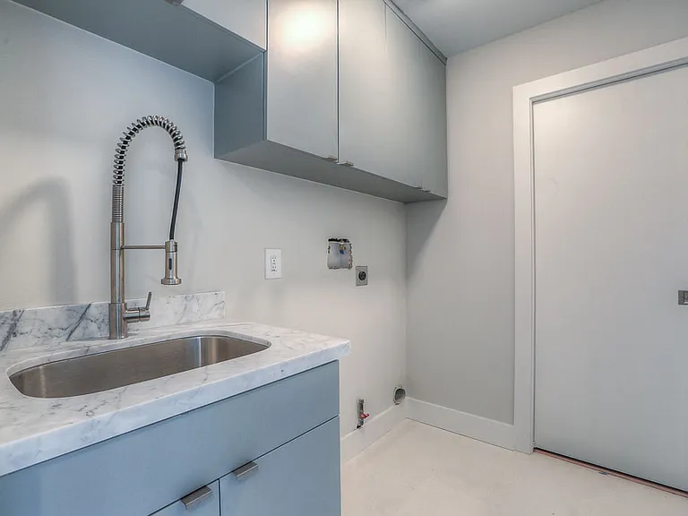 Laundry room with Carrara marble counter, stainless commercial-style faucet, deep utility sink, and full washer/dryer hookups (W/D are included)