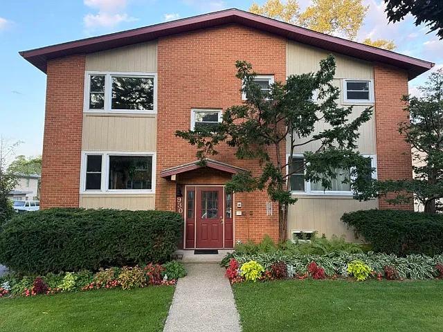 The exterior. Available unit is top left window (living room).