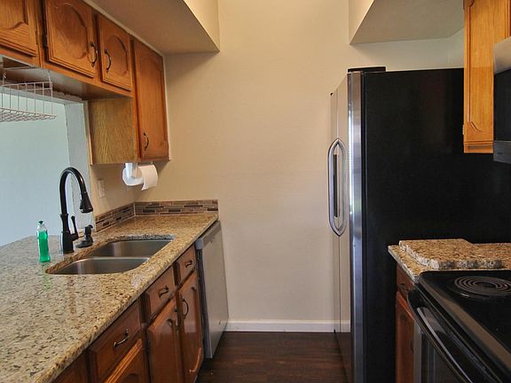 Kitchen has granite counter and stainless steel appliances