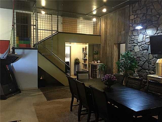 View of loft from dining room
						:
						Beautiful textures in this space - wood, brick, pebble, rock. Fireplace.