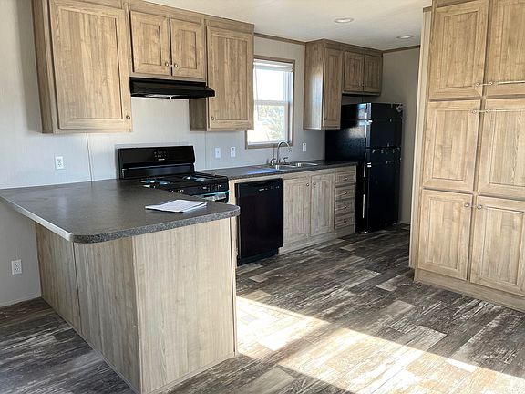 Open Kitchen - Black Appliances - Tall Pantry Cabinets