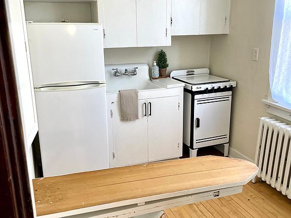 Ironing board hidden behind the fold down table.