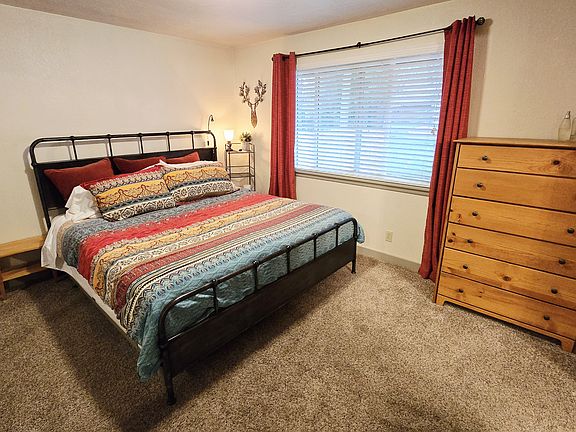 Primary bedroom w/ King bed.