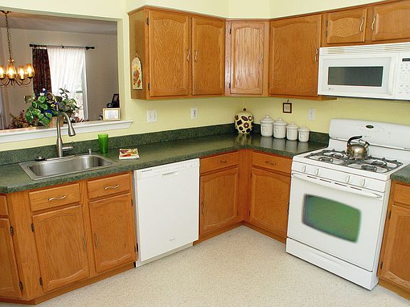 Kitchen work area with plenty of cabinets, built-in dishwasher and built-in micorwave.