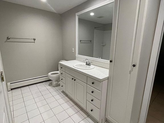 bathroom with vanity and linen tower