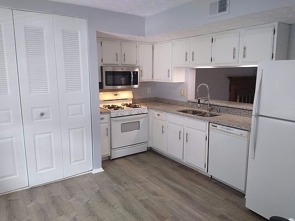 Kitchen - Washer dryer connections are behind the bi-fold doors, Range and OTR microwave , granite counter tops, Professional double faucet