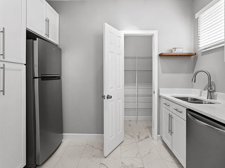 Kitchen with plenty of storage boasting both a walk-in and pull-out pantry