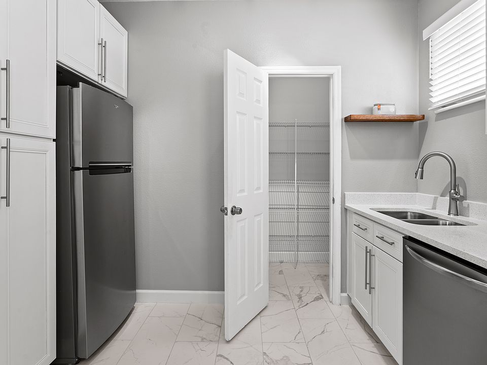 Kitchen with plenty of storage boasting both a walk-in and pull-out pantry