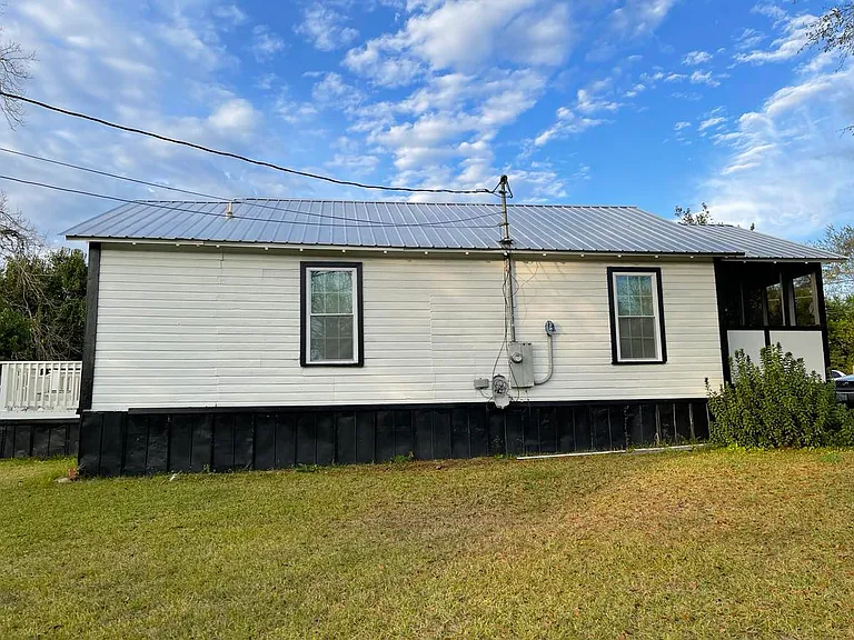 Corner lot side view; partial view of deck