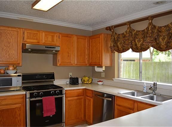 Kitchen with Custom window treatments, Replaced Appliances, overlooks huge yard