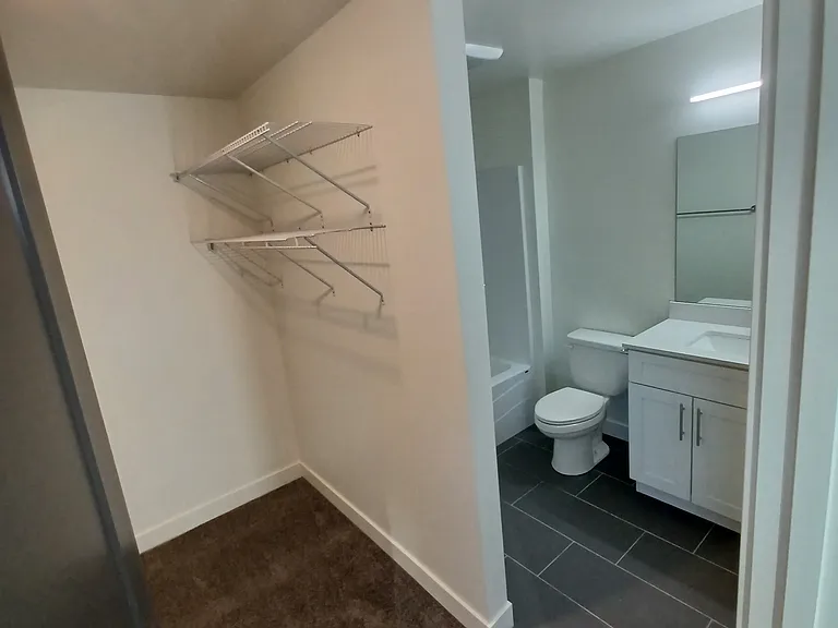 Walk-in closet and ensuite bathroom in 2 bedroom Anthony unit