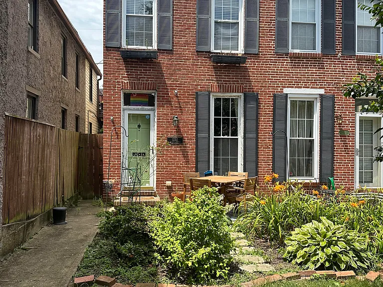 Front of historic house with lush garden and rare front lawn 2024
