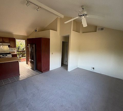 Kitchen adjoins open plan living/dining area with cathedral ceilings and fabulous views from all the windows