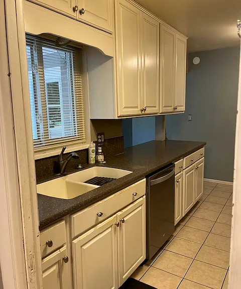 Kitchen - nice white cabinets with attractive brown counter top. Stainless steel appliances.