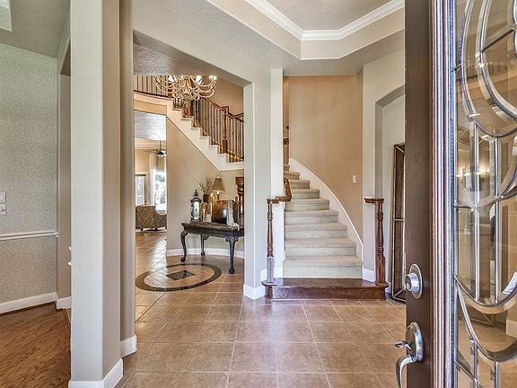 WELCOME HOME TO THE GORGEOUS, ELEGANT ENTRYWAY. TWO STAIRWAYS ON EITHER SIDE FOR A GRAND ENTRANCE. HIGH, TRAYED CEILINGS THROUGH