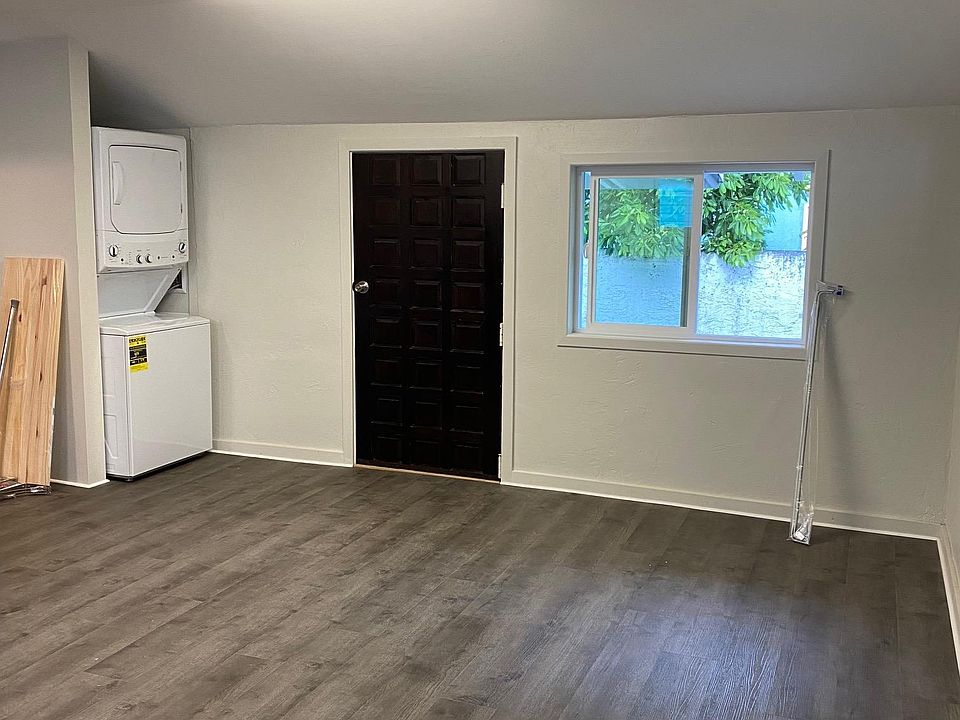Private entrance into a large living space with washer dryer