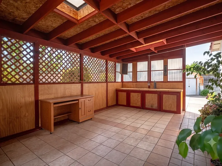 Covered California room with skylight, built-in cabinets, and tile floor