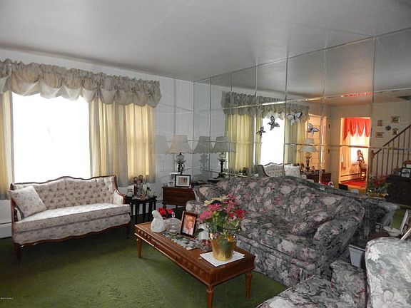 Room appears larger with use of mirrored wall