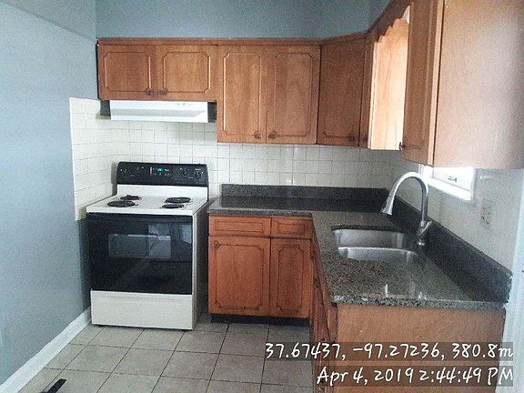 Kitchen with granite and range / hood