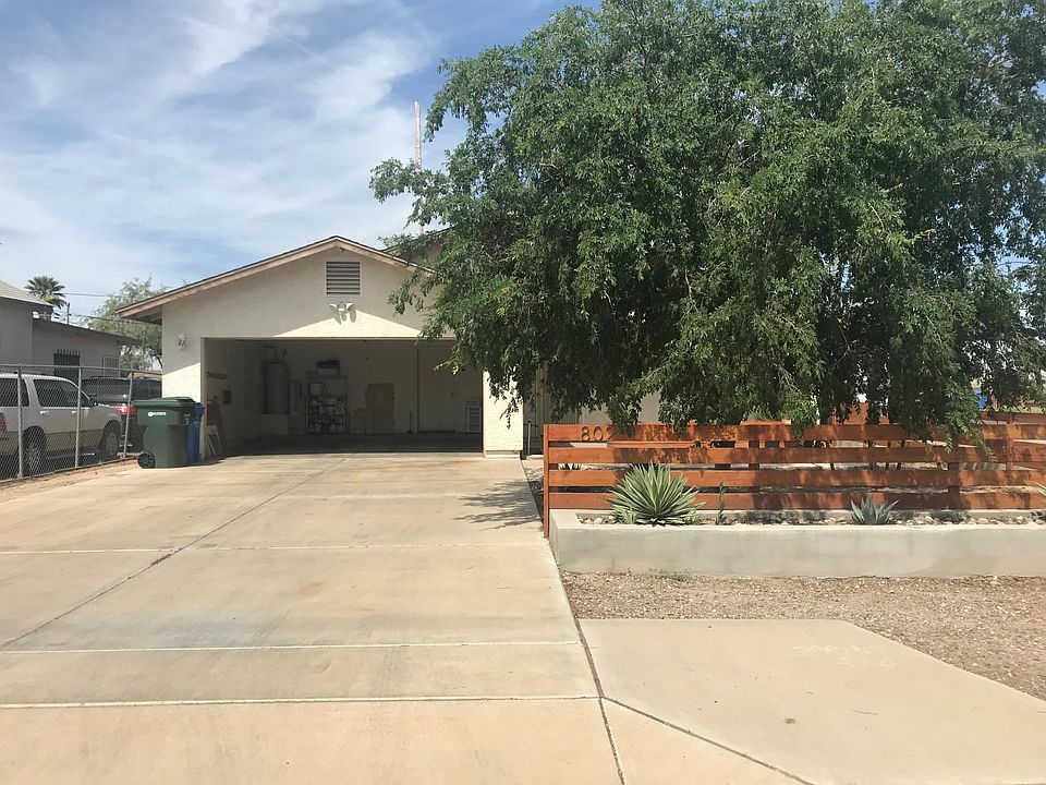 Welcome home! This photo was taken in the summertime. The tree is bare now, but will be green again in the spring.