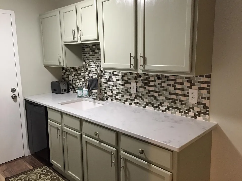 Kitchen with separate entrance - marble countertops - dishwasher