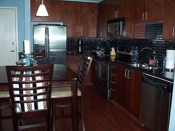 Kitchen has granite and stainless steel appliances